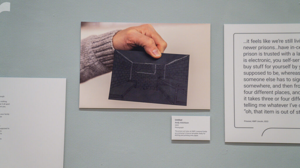 The prison art tutor at HMP Liverpool holds up a prisoner's linocut template ready for etching and printing onto paper. 2023.