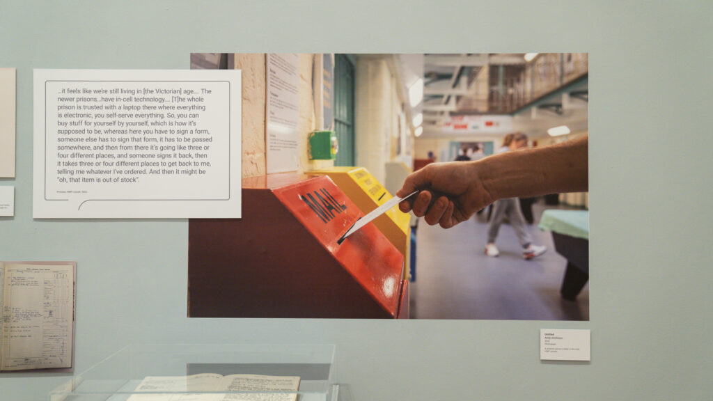 A prisoner places a letter in the mail, HMP/YOI Lincoln, 2022